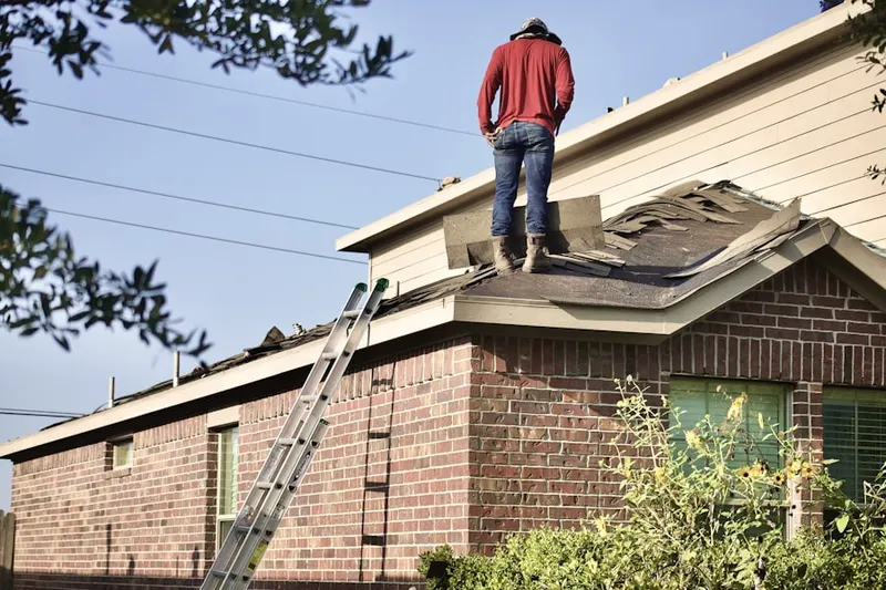 Professional roofer working on a residential roof in Colton